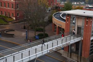 A girl walking across a bridge on the WVU Downtown Campus